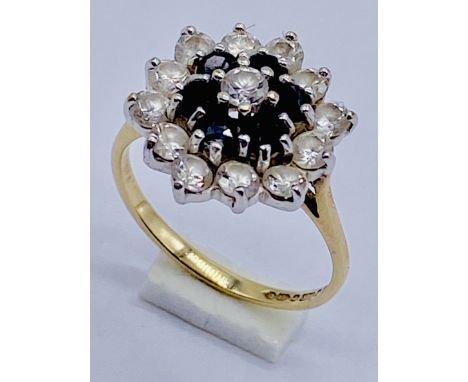 A diamond and sapphire cluster ring set in 14ct gold, size J