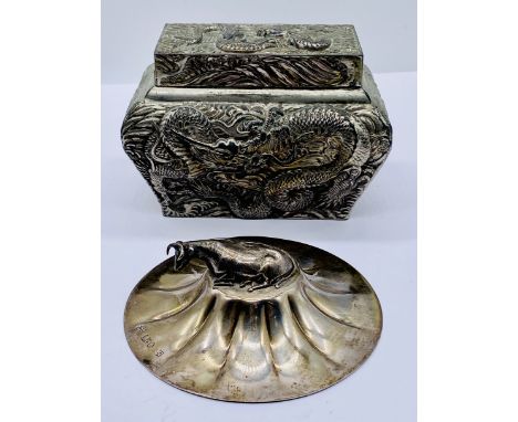 A Japanese casket shaped tea caddy depicting three claw water dragons amidst crashing waves along with a hallmarked silver bi