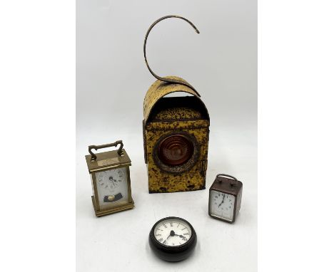 A Chalwyn road/railway lamp, painted yellow, along with a Metamec carriage clock and two others 