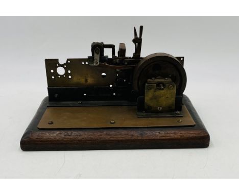 A vintage live steam engine, mounted on a wooden plinth - overall length 27cm