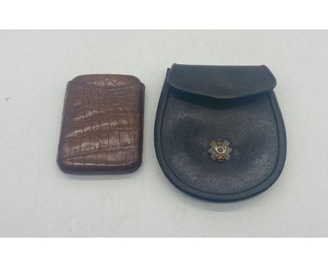 A day sporran along with a crocodile skin cigar case. The sporran is stamped Wm Anderson & Sons, Military Outfitters, Glasgow