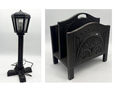 A small wooden lamp on carved base along with a carved wooden magazine rack 