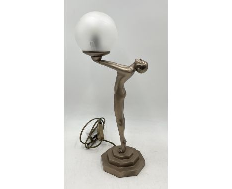 An Art Deco style table lamp in the form of a nude female holding a globe - Overall height 50cm