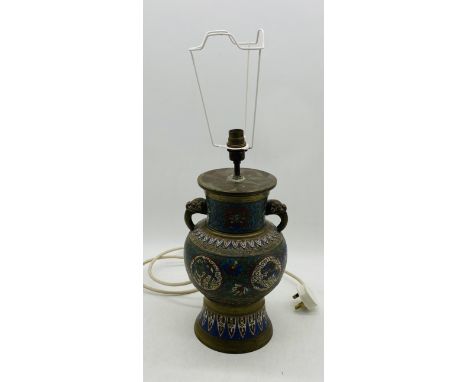 A vintage Cloisonné lamp dipicting exotic birds and dragons with elephant handles 