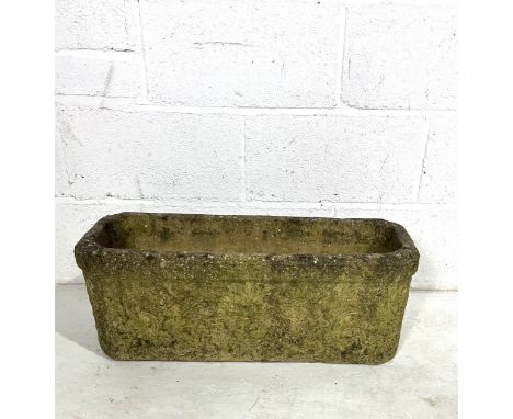 A reconstitued stone garden trough.