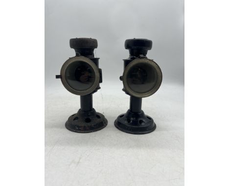 A pair of W.W.2 British Army candle lamps, one clearly marked with broad arrow 1942, Bladon & Son Ltd, the other marked the s