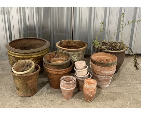 A collection of various terracotta pots along with a large earthenware planter with Chinese dragon motif 