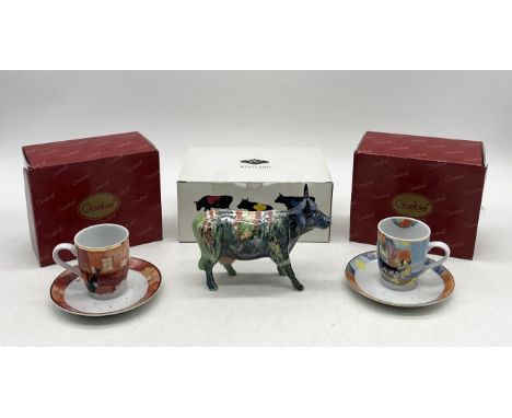 A boxed Cow Parade ceramic figurine with multi coloured design along with two boxed Goebel Rosina Wachtmeister teacups