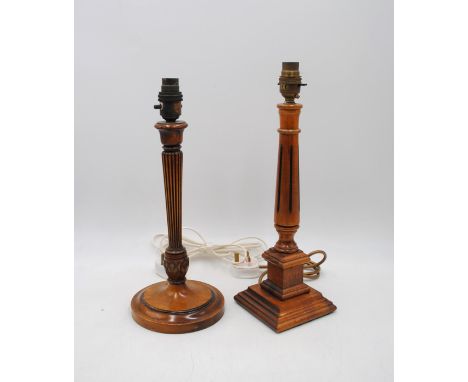 A wooden table lamp with fluted column decoration, along with another wooden table lamp