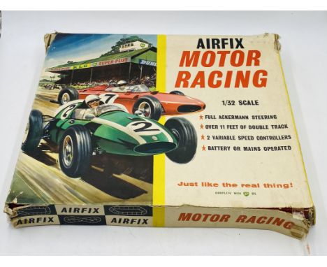 A boxed vintage 1960's Airfix Motor Racing set (1:32 scale) including two cars, barriers, controllers track etc