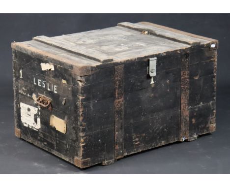 A late 19th/early 20th century black painted deal travelling trunk with a hinged lift-lid &amp; with rope side handles, 104cm