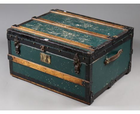 A vintage green painted &amp; steel-bound travelling trunk with a hinged lift-lid &amp; with leather side handles, 76cm wide 