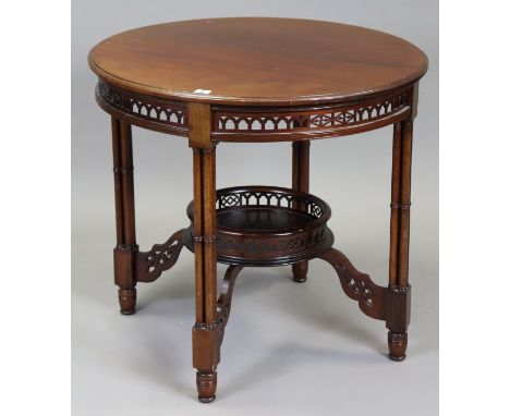 A Chippendale-style mahogany circular two-tier occasional table, having a pierced frieze, &amp; on four column supports &amp;