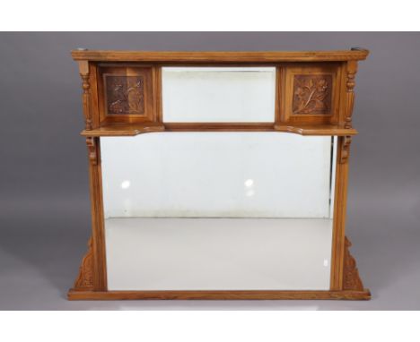 A Victorian mahogany overmantel, inset two bevelled mirror plates, with decorative carved panels to either side, above a smal