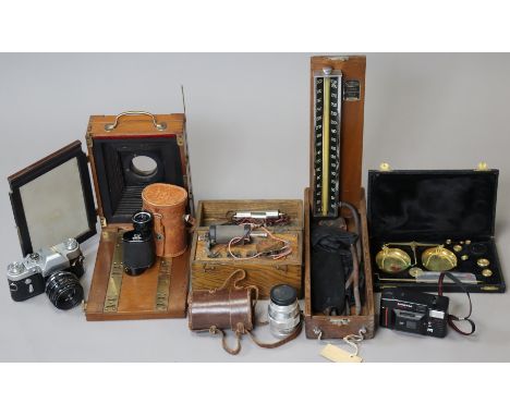 A vintage mahogany plate camera; a Zenit 3M camera; a Heinz 7 x 30mm monocular scope; a brass beam scale, cased, etc.