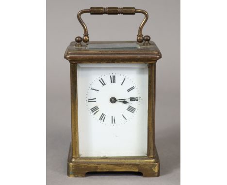 A French brass carriage timepiece with black roman numerals to the white enamel dial; 10.5cm high. 