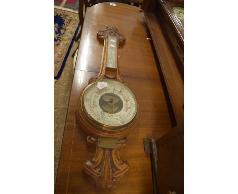 LATE 19TH CENTURY OAK CASED ANEROID BAROMETER AND THERMOMETER COMBINATION BEARING RETAILERS NAME A.E. COE, NORWICH