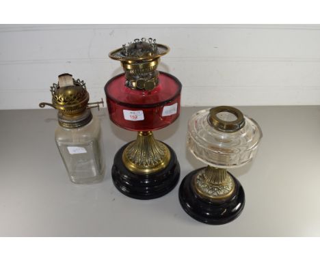 VICTORIAN OIL LAMP BASE WITH CRANBERRY GLASS FONT TOGETHER WITH TWO FURTHER OIL LAMP BASES