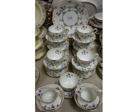 A Staffordshire New Chelsea floral pinted tea set, comprising eleven cups, eleven saucers, twelve side plates, two milk jugs,