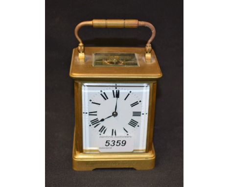 A brass carriage clock, white enamelled dial, Roman numerals, inscription from Old Girls of Orme School 1914