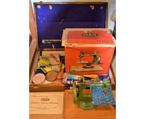 A boxed Grain miniature sewing machine; assorted button accoutrements; etc.; quantity