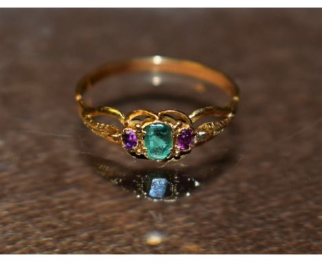 A yellow metal lady's dress ring, amethyst and emerald stone