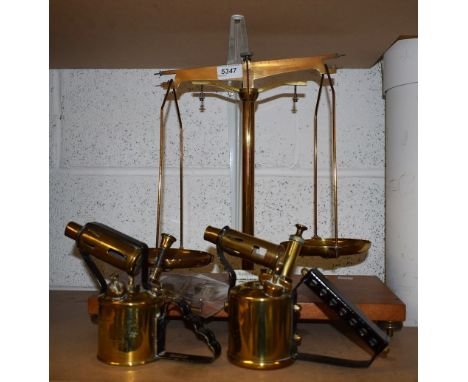 A set of brass balance scales; two brass blow lamps; a brass pocket compass; a glass cutter and a magnifying glass