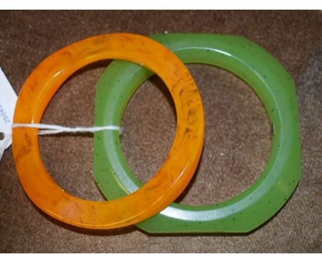 A Christian Dior Germany plastic bracelet in jade tones; another in amber tones