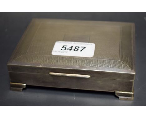 A hallmarked silver Art Deco style cigarette box, engine turned design, vacant cartouche