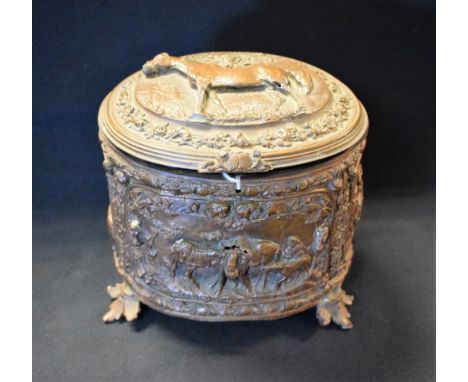 A 19th century bronzed spelter oval trinket box, the cover and sides embossed in relief with horses, figures and foliage, lea