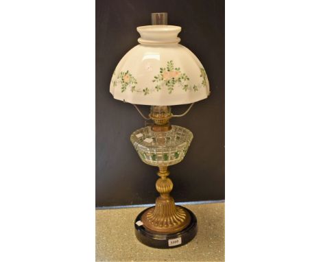 A Victorian cut clear and green flashed glass oil lamp, gilt bulbous column, splayed foot with shaped opaque painted shade, V