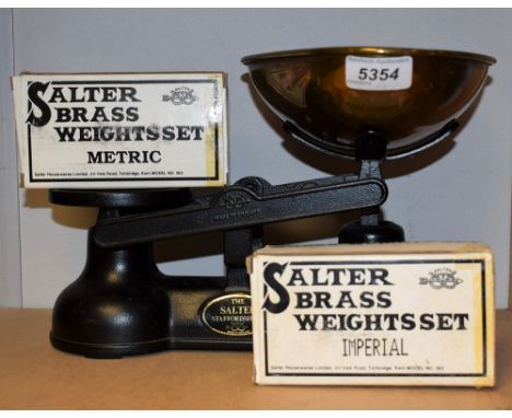 A set of Salter cast iron kitchen balance scales, two set of graduated brass bell weights, Imperial and Metric