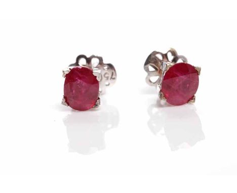 PAIR OF RUBY STUD EARRINGSeach set with an oval ruby of approximately 1.25 carats, in eighteen carat white gold