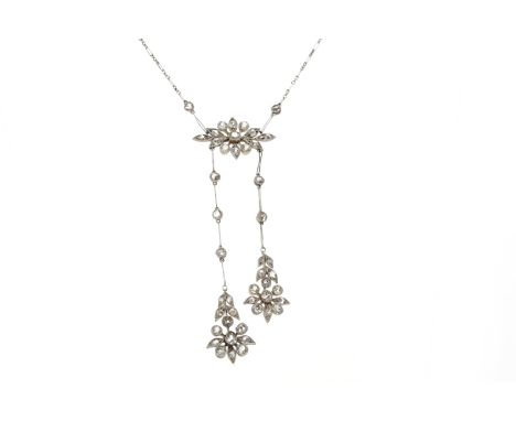 EARLY TWENTIETH CENTURY DIAMOND NECKLET of floral design, with a large central flower and two floral drops, set with old Euro