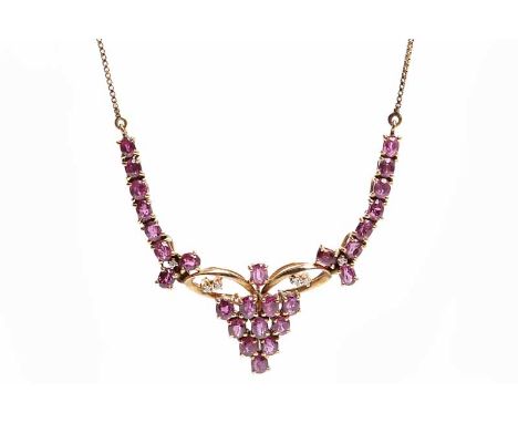 FOURTEEN CARAT GOLD RUBY AND DIAMOND NECKLETset with round rubies and six small diamonds