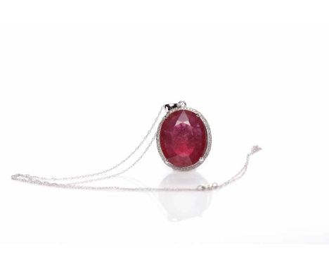 LARGE RUBY PENDANTthe oval ruby of approximately 21.00 carats in a diamond setting, in fourteen carat white gold, on a chain