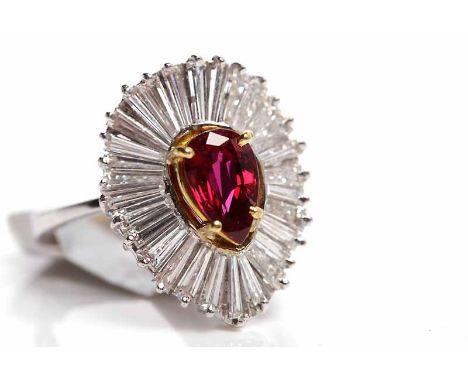 RUBY AND DIAMOND CLUSTER RINGthe central pear shaped ruby 8mm long surrounded by taper cut diamonds, in eighteen carat white 