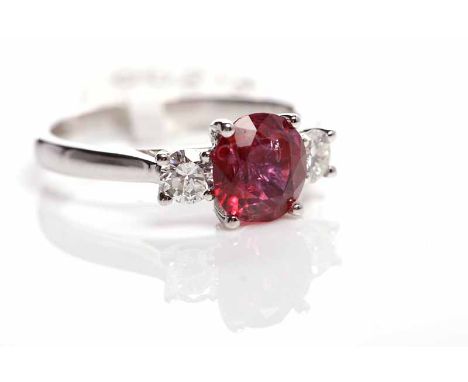 RUBY AND DIAMOND THREE STONE RINGthe central round ruby of approximately 1.97 carats flanked by two diamonds totalling approx