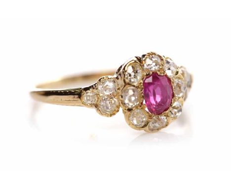 VICTORIAN RUBY AND DIAMOND CLUSTER RINGset with a central oval ruby of approximately 0.37 carats, surrounded by a row of bril