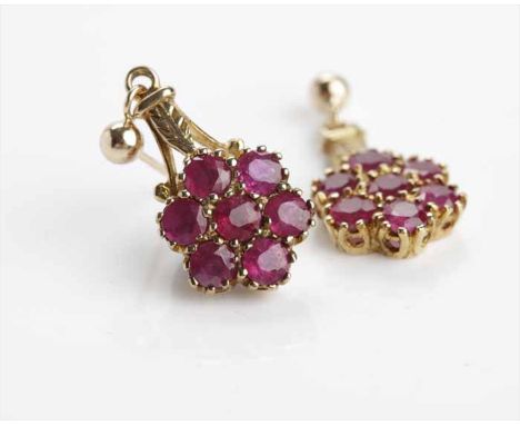 ATTRACTIVE RUBY DROP EARRINGSeach set with seven round rubies of 3mm diameter in a daisy motif cluster 11mm across, below a f