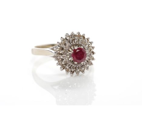 RUBY AND DIAMOND CLUSTER RINGthe high set bezel with a central round ruby surrounded by two rows of round diamonds, in eighte