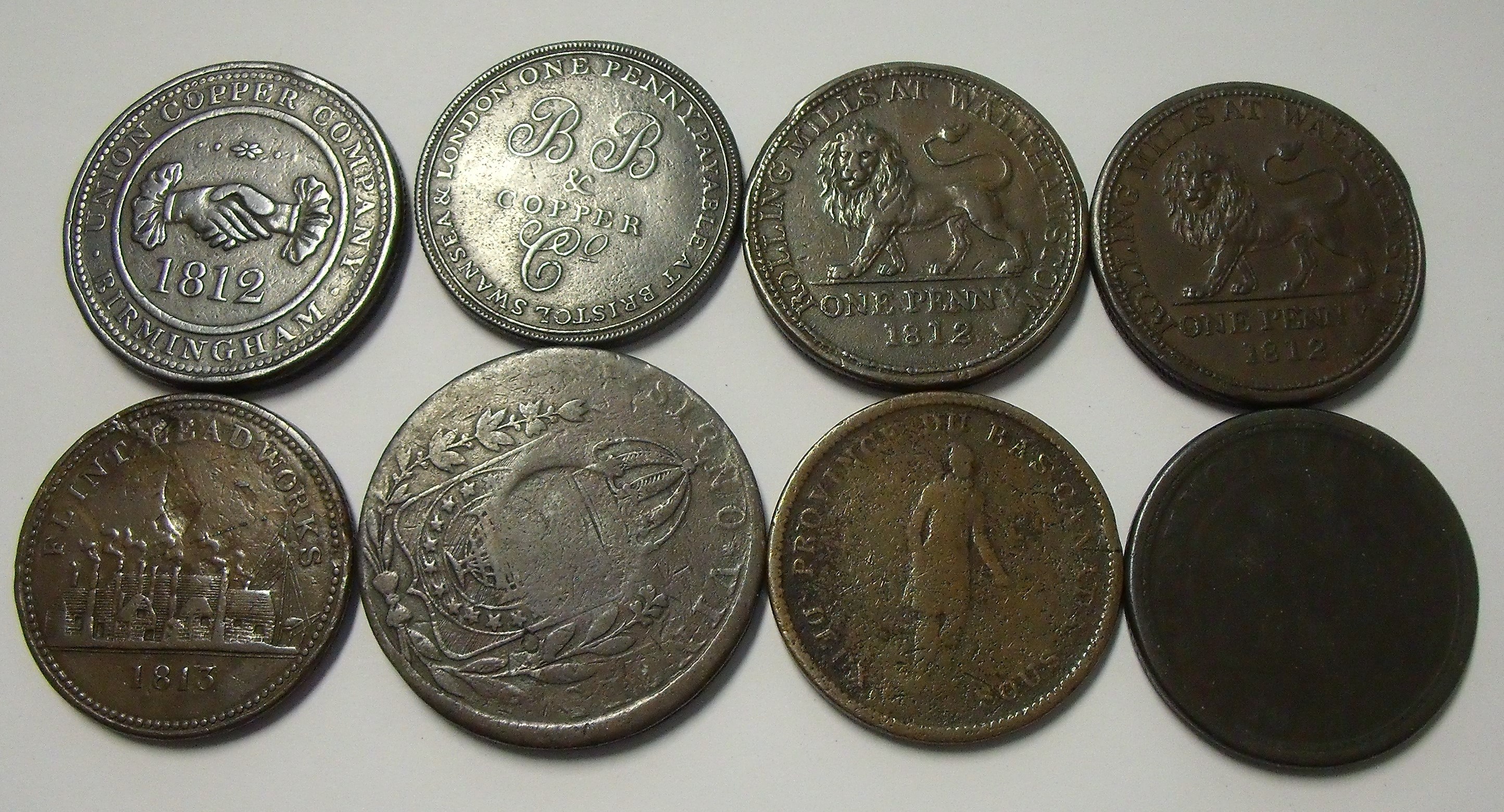 A group of eight Georgian copper tokens including 1812 Union Copper ...