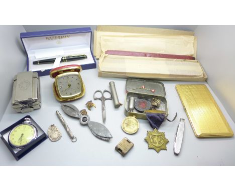 A Waterman ink pen, a slab of Superfine Sealing Wax, travel clock, tin of medallions, plated cigarette case, a WWI Victory me