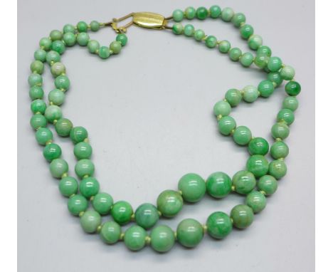 A double strand jade bead necklace, 35/36cm, fastener requires attention 
