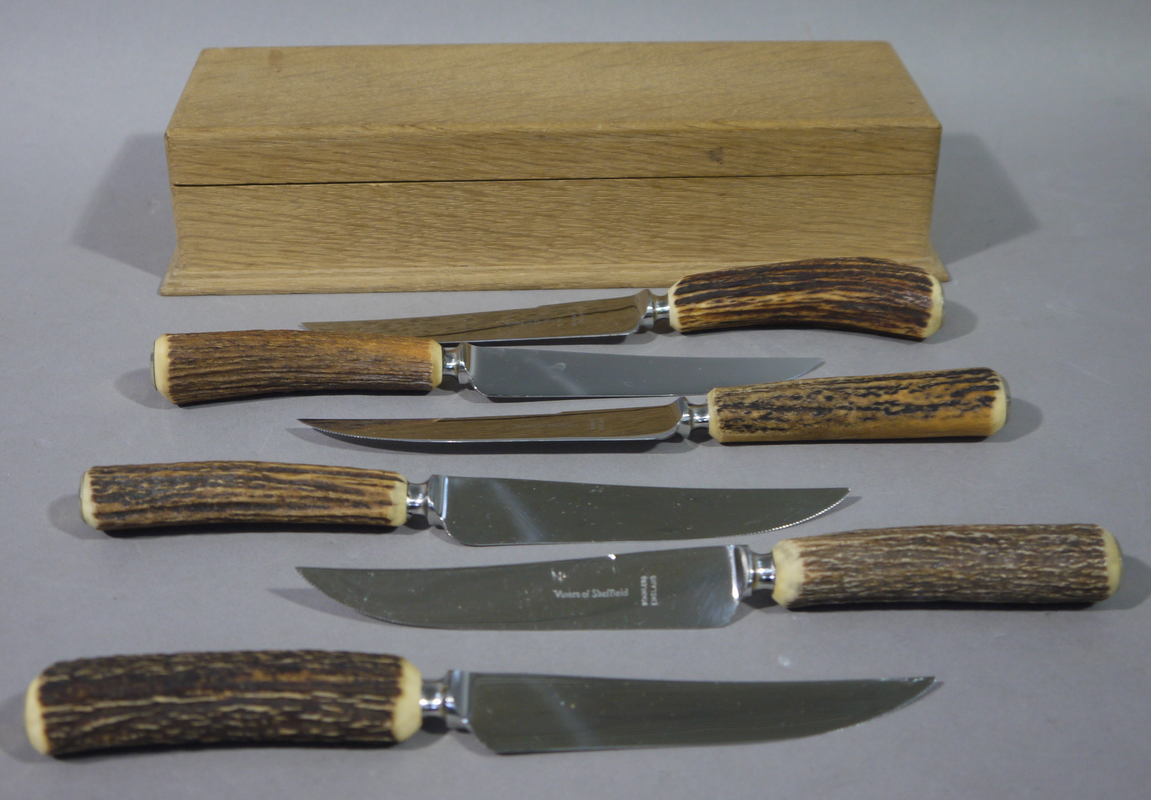 A set of six antler handled stainless steel steak knives by Viners of