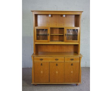 A modern light oak veneered china cabinet, with glass fronted cabinets and niches over a base with drawers and cupboards, 192