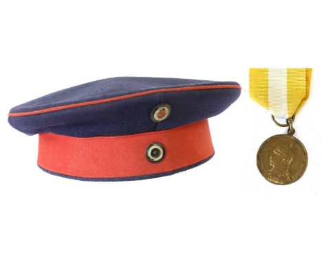 A First World War Prussian EM's Pillbox Type Field Cap, in navy blue with crimson piping and hat band, with Prussian and Nati