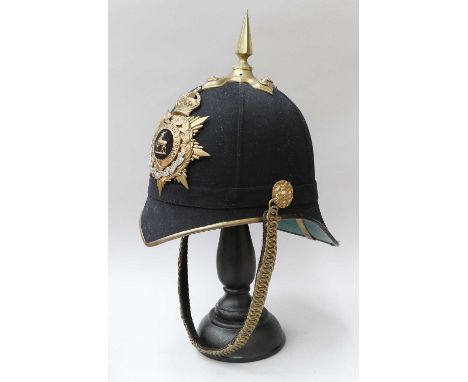 A Post-1902 Officer's Home Service Helmet to the Royal Warwickshire Regiment, the blue cloth covered cork body with gilt meta
