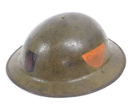 A First World War Mark I Brodie Combat Helmet, with dark khaki finish, the front badged to the 36th (Ulster) Division, the le