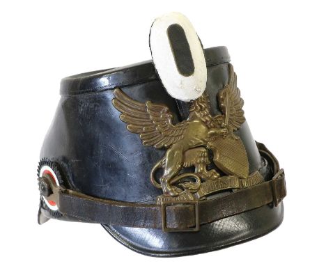 A First World War Imperial German EM's Shako, in black leather with circular top, exaggerated ogee back skull, front and back